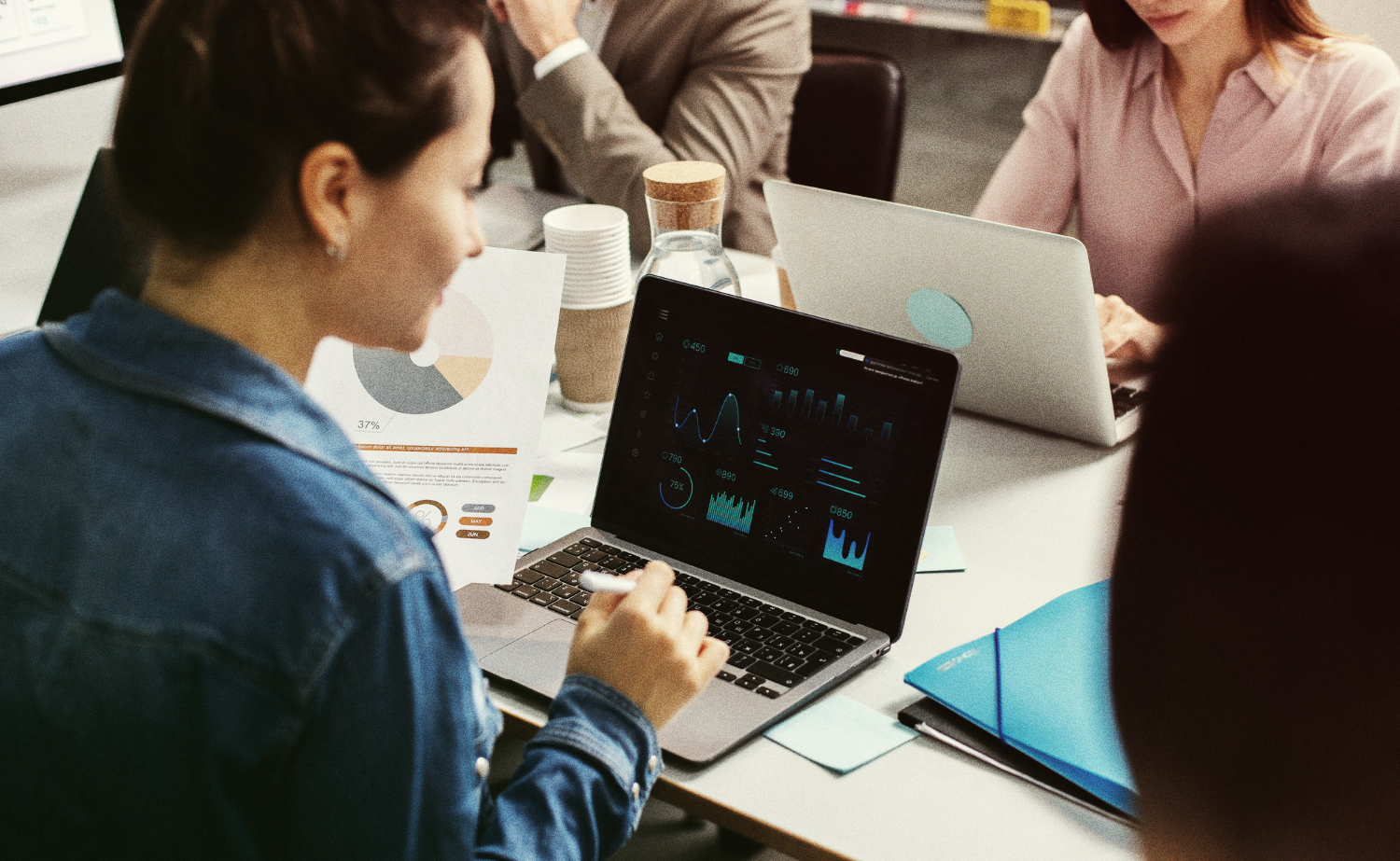 woman-looking-at-laptop-with-charts-and-graphs