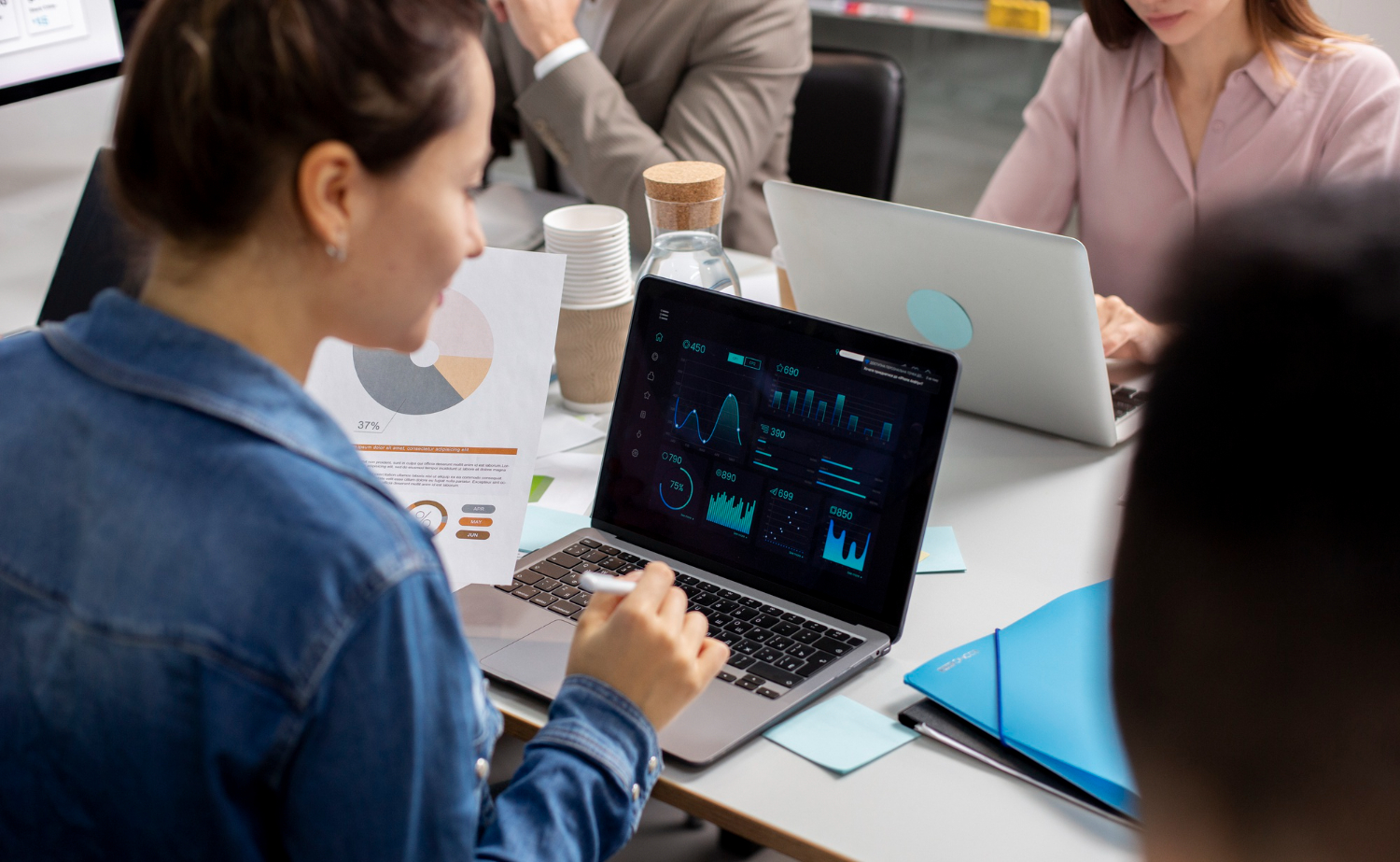 woman looking at laptop with charts and graphs