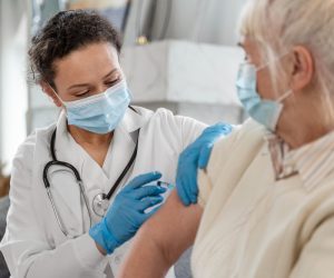 doctor-vaccinating-senior-woman